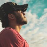 Mindfulness - Man Wearing Black Cap With Eyes Closed Under Cloudy Sky