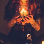 Myths - Spooky witch among candles during ritual