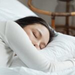 Naps - Young woman sleeping in comfy bed