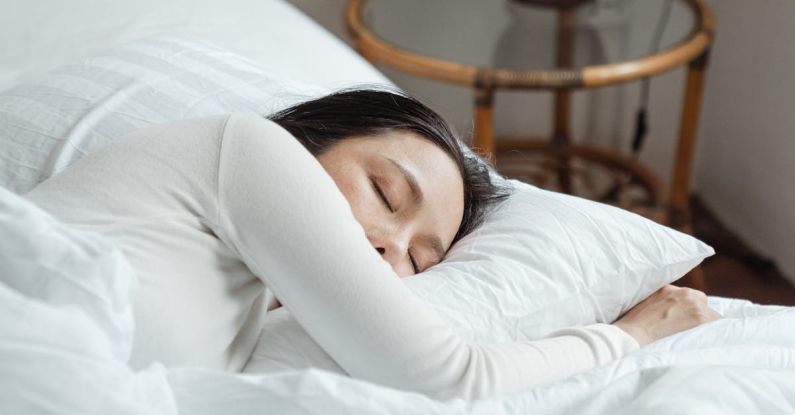 Naps - Young woman sleeping in comfy bed