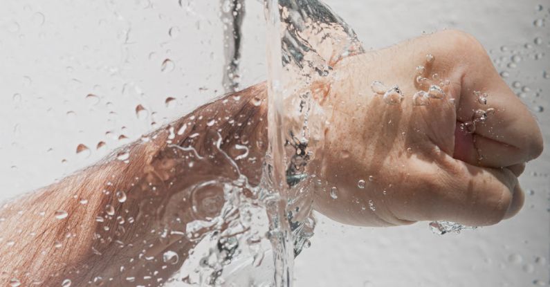 Hygiene - Person's Left Fist Punching Water