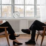 Practices - Person in Black Pants and Black Shoes Sitting on Brown Wooden Chair