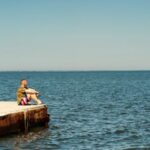 Dreams - Man Sitting on Dock