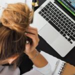 Stress - Woman Sitting in Front of Macbook