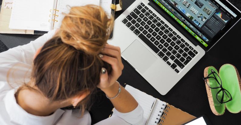 Stress - Woman Sitting in Front of Macbook