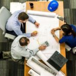 Management - Three People Sitting Beside Table