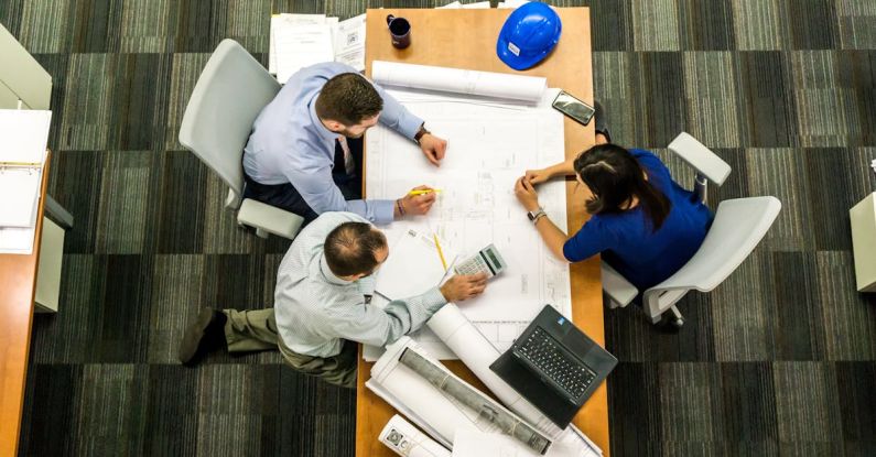 Management - Three People Sitting Beside Table